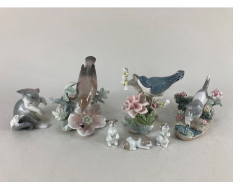 Two Lladro porcelain models of birds on flowering branches, a model of a cat with a mouse and a cat with a frog, and three sm