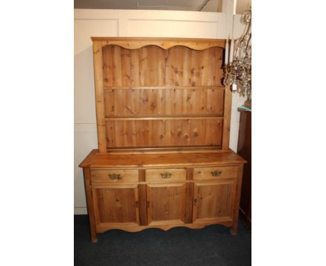 A modern pine dresser with three drawers and cupboards 154cm with an associated pine two shelf back 139cm