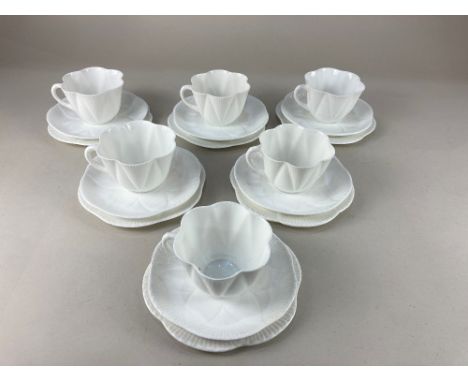 A Shelley porcelain tea set for six, of scalloped floral form in white glaze, comprising six teacups, saucers and teaplates