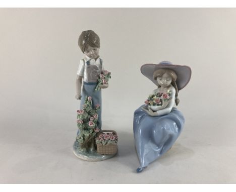 Two Lladro porcelain figures of a boy cutting roses and a girl holding a bouquet of flowers, tallest 26cm high