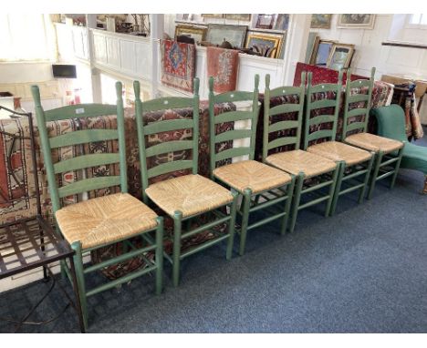 A set of six green stained ladder back dining chairs, with wicker seats