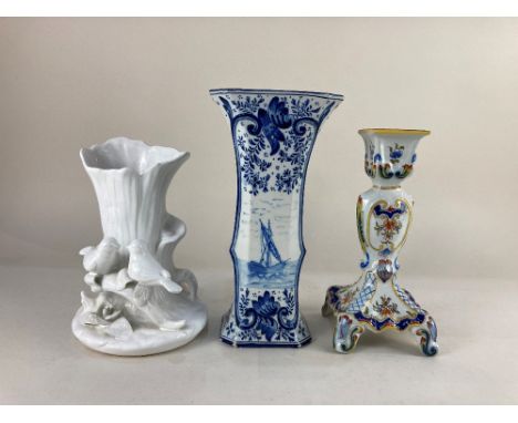 A Delft blue and white porcelain vase, depicting a ship at sea within floral patterned ground, 27.5cm high, together with a C