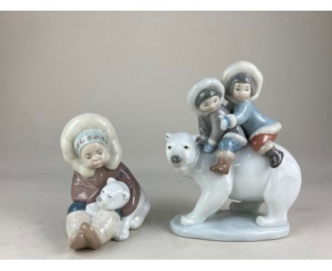 Two Lladro porcelain figures, Eskimo Riders and Eskimo playing with polar bear cub, both in original boxes, tallest 17cm high