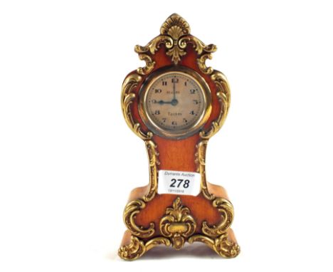 A small Edwardian wood and Brass mantel clock