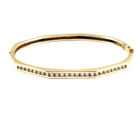 A 14ct Gold Diamond set bangle