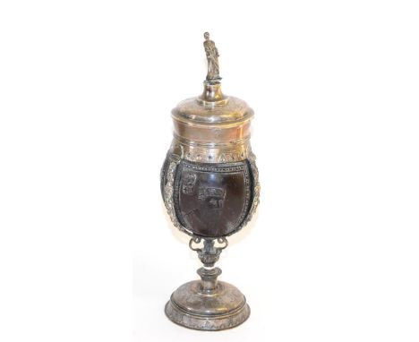 A German White Metal Mounted Coconut Cup and Cover, in 17th century style, the slightly domed cover with figural finial over 