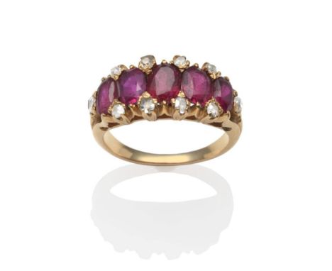 A Ruby and Diamond Ring, five oval cut rubies spaced by old cut diamond accents in yellow claw settings, to tapering shoulder