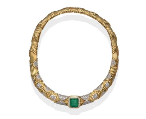 An Emerald and Diamond Necklace, the emerald within a border of baguette cut diamonds, on a collar of ridged form, pavé set w