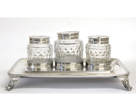 A George III Silver Inkstand, Henry Chawner, London 1791, rounded rectangular with a reeded border, raised on four scroll fee