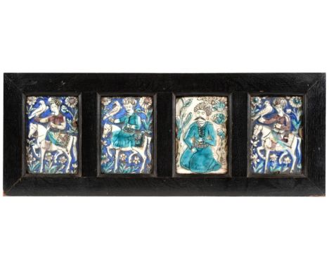 Four Qajar Faience Tiles, 19th century, three moulded as figures on horseback holding hunting birds, the fourth as a kneeling