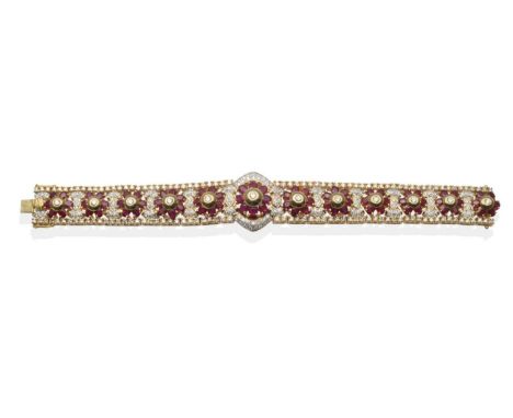 A Ruby and Diamond Bracelet, a central cluster of a round brilliant cut diamond in a domed mount within a border of oval cut 