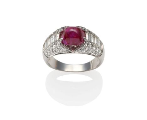 A Ruby and Diamond Ring, a cabochon ruby in a white claw setting between rows of channel set baguette cut diamonds and a pavé