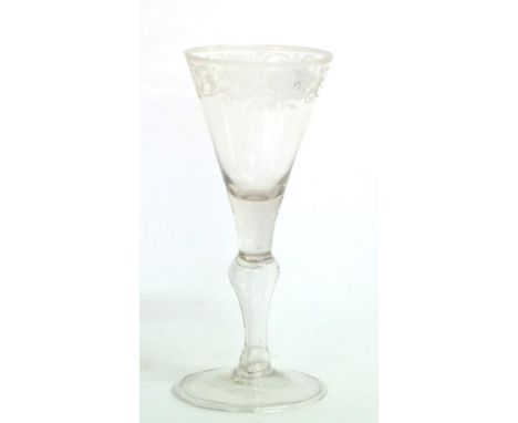 A Light Baluster Wine Glass, circa 1750, the funnel bowl engraved with a band of scrolling foliage, on a baluster stem and fo