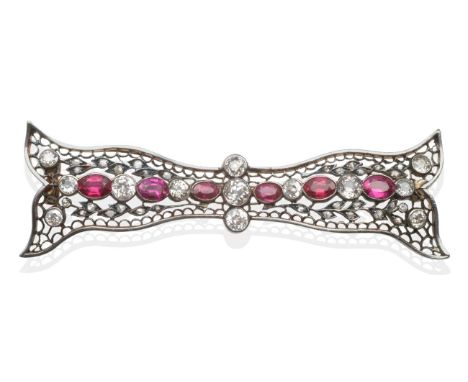 A Ruby and Diamond Bow Brooch, the pierced bow set throughout with old cut diamonds and oval cut rubies in white rubbed over 