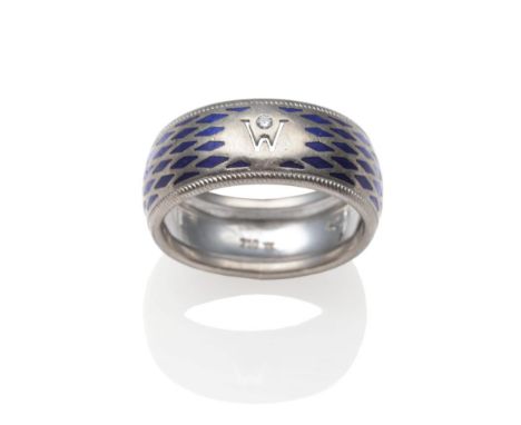 A Diamond and Blue Enamel Band Ring, by Wellendorff, inset with a round brilliant cut diamond above a pierced 'W' and picked 