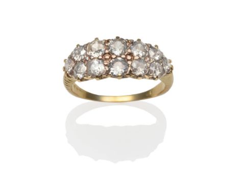 A Diamond Two Row Ring, twelve old cut diamonds in yellow claw settings to scroll shoulders on a plain polished shank, total 