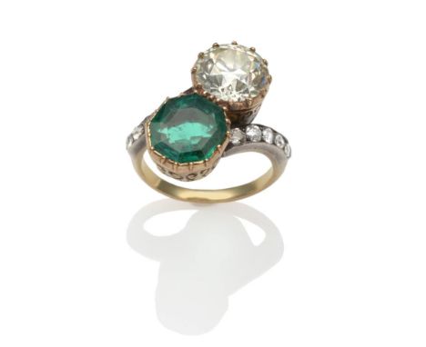 An Emerald and Diamond Two Stone Twist Ring, an octagonal step cut emerald and an old brilliant cut diamond in yellow collet 