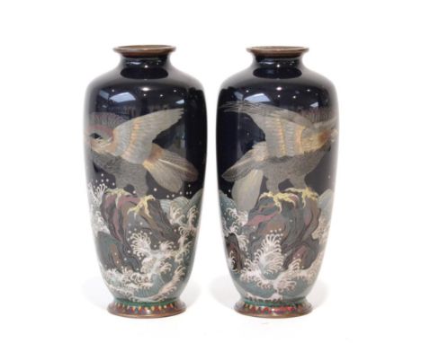 A Pair of Japanese Cloisonné Enamel Baluster Vases, Meiji period, decorated with eagles perched on rocks amongst waves on a b