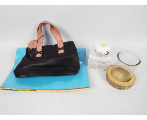 A mixed lot to include a black pvc handbag with pink straps, a boxed tealight holder with a tea light and marked "Love you to