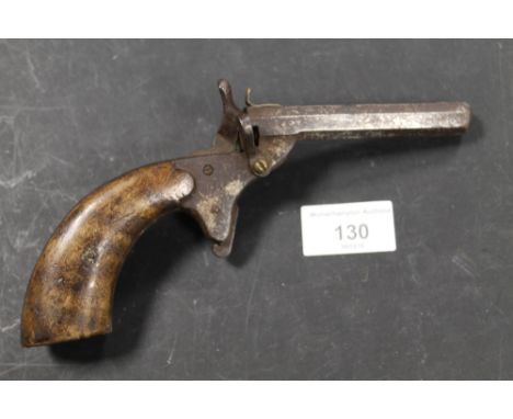 AN ANTIQUE SINGLE SHOT PISTOL WITH WOODEN HANDLEBuyer Please Note: This item must be collected by the named purchaser in pers