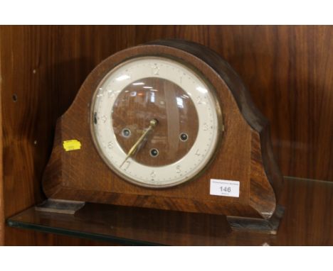 AN OAK FRAMED MANTEL CLOCK