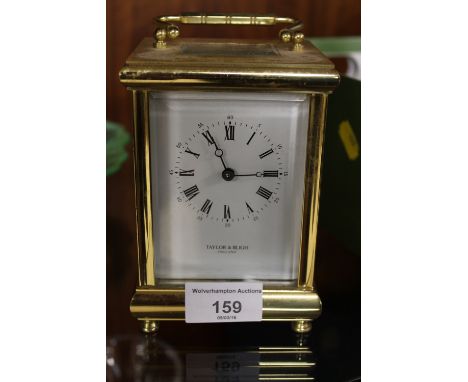 A 'TAYLOR AND BLIGH' CARRIAGE CLOCK WITH PLAQUE TO THE REAR ENGRAVED 'PRESENTED TO E.F. GRIFFITHS, BY CHUBB FOR 25 YEARS SERV