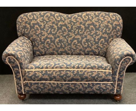 A Victorian drop arm two seater sofa, scrolling floral upholstery, 91cm high, 157cm long. 