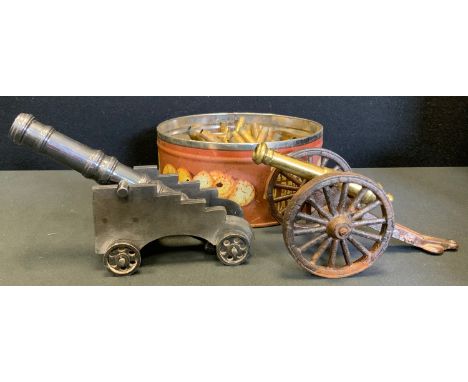 A cast iron and brass model field gun cannon, solid barrel, 20.5cm long;  another smaller;  spent shell cases etc. 