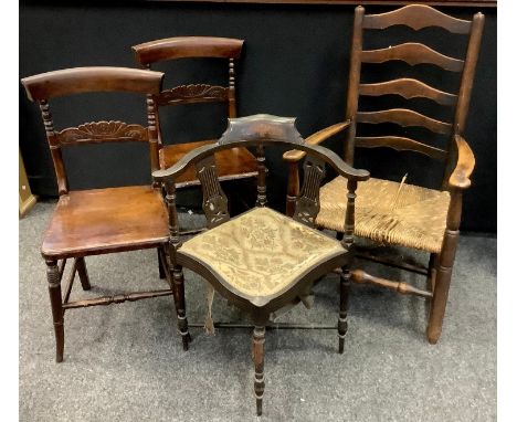 A Victorian ebonised corner chair, shaped cresting rail, pierced and shaped splats, tapestry seat, turned legs and X-frame st