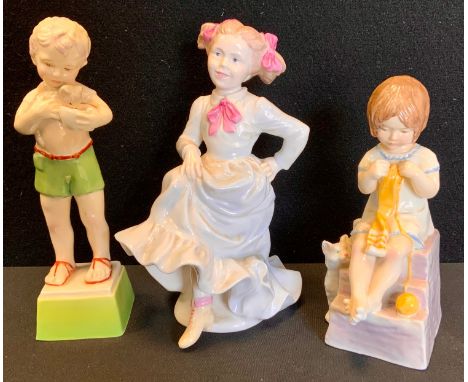 A Royal Worcester figure, Fridays Child is Loving and Caring, black marks;  another Saturdays Child;  a Coalport figure Sunda