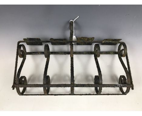 A vintage wrought-iron milk bottle holder