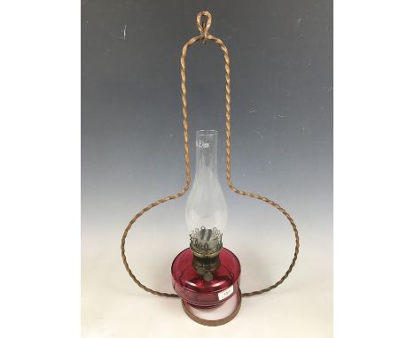 A pendant cranberry glass oil lamp
