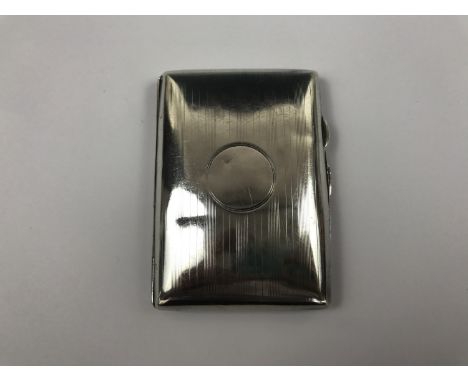 A silver cigarette case with engine-turned decoration and a vacant cartouche