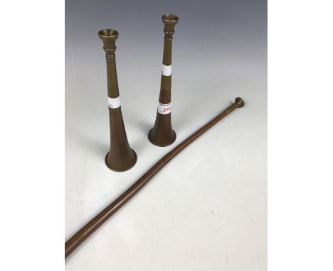 Two small copper and brass hunting horns together with one larger hunting / coaching horn