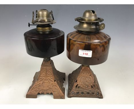 Two cast-metal and glass oil lamp bases