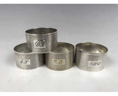 Three Harrison Brothers silver napkin rings together with a Crisford & Norris silver napkin ring