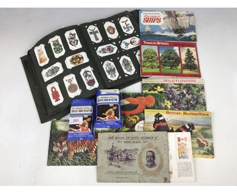 An album of vintage cigarette cards, including football themed cards and sundry tea cards
