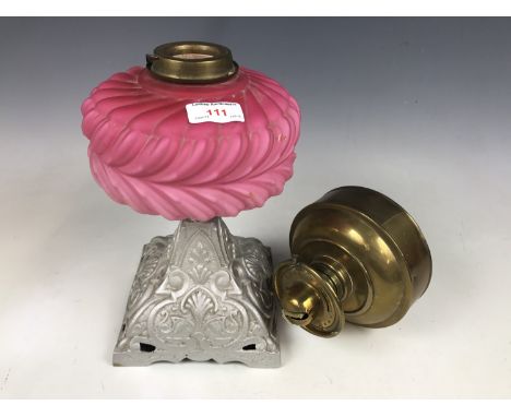 A cast metal and pink opaline glass oil lamp base, together with a brass reservoir