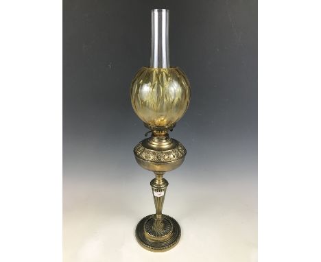 A brass and amber glass oil lamp 77 cm