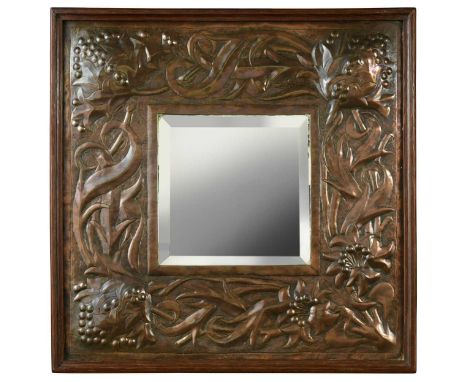 An Arts & Crafts copper wall mirror,  the bevelled square mirror plate with embossed copper frame decorated with foliate moti