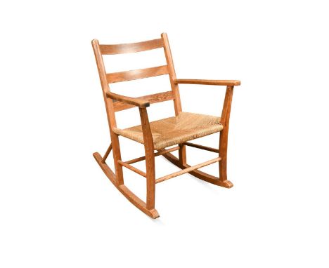 A Norwegian pine ladder back rocking chair, circa 1930s,  with rush seat82cm high