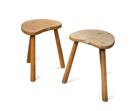 Robert 'Mouseman' Thompson, a pair of three-legged oak stools, the kidney form tops raised on octagonal section legs, each wi