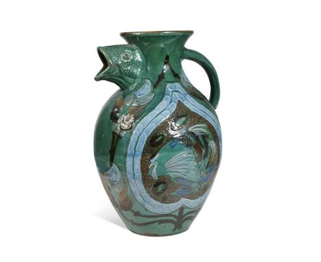 James Dewdney for C.H. Brannam Barum Pottery, a large fish jug, 1897, the baluster body with fish head spout, slip decorated 