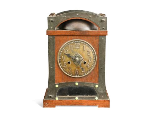 An Arts & Crafts oak mantle clock, probably retailed by Liberty & Co.,  the oak case with embossed brass dial and mounts, the