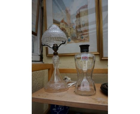 A cut glass table lamp and shade, 37cm high, (chips to rim of shade); together with a silver mounted clear glass decanter, (l