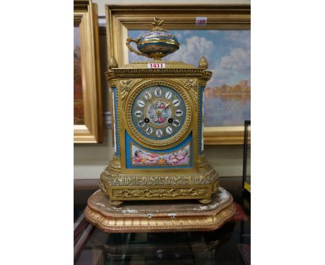 A late 19th century gilt metal and porcelain mounted mantel clock, in the Sevres style, striking on a bell, 35.5cm high, on g