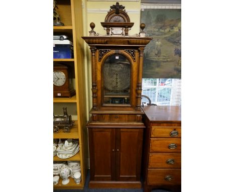 A late 19th century walnut cased Polyphon&nbsp;coin-operated upright music box, with six 19? inch disks and one further 15½ i