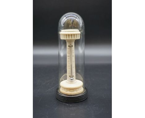 A Victorian combined thermometer and compass,&nbsp;of pedestal form, on ebonized base, 14cm high, with glass dome, (dome repa