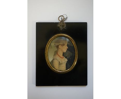 Attributed to Thomas Carlyle,&nbsp;bust-length portrait miniature of a young lady wearing a red bead necklace, in profile, in