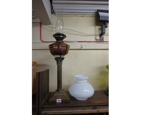 (LC) A brass Corinthian column oil lamp,&nbsp;with copper reservoir and opaque glass shade, height excluding chimney 67cm.&nb